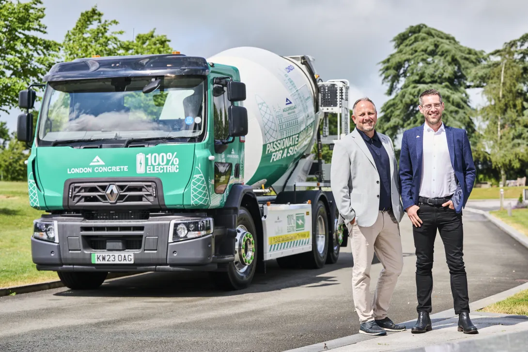 London Concrete Director Danny King and Readymix business division Managing Director Lee Sleigh standing in front of Aggregate Industries' first electric concrete mixer to be deployed in London.