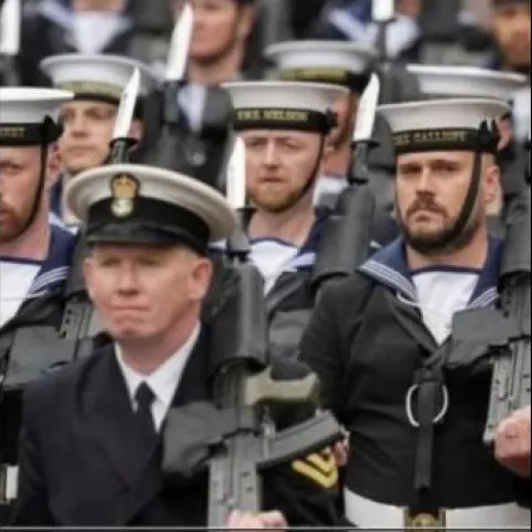 Navy Reservist Chris Willett marches in full uniform with other service men and women at the King's Coronation ceremony